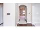 Hallway with hardwood flooring, neutral walls and an arched doorway to the next room at 1661 Devonshire Ave, Avon, IN 46123