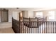 Second story hallway with wooden banister and chandelier at 1661 Devonshire Ave, Avon, IN 46123