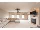 Bright living room with a comfortable sectional sofa, fireplace, and elegant ceiling fan at 1661 Devonshire Ave, Avon, IN 46123