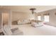 Spacious living room with a large sectional sofa, ceiling fan, and neutral-toned decor at 1661 Devonshire Ave, Avon, IN 46123