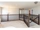 Upstairs loft space featuring neutral carpeting, railing, and chandelier at 1661 Devonshire Ave, Avon, IN 46123