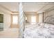 The main bedroom boasts a luxurious four-post bed and bright windows at 1661 Devonshire Ave, Avon, IN 46123