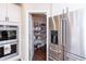 Kitchen featuring stainless steel refrigerator and walk-in pantry with ample storage space at 1661 Devonshire Ave, Avon, IN 46123