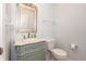 Charming powder room features a decorative vanity with mirror and white toilet at 1661 Devonshire Ave, Avon, IN 46123
