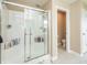 A modern shower stall features glass doors and built-in shelving at 1661 Devonshire Ave, Avon, IN 46123