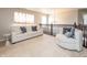 Bright upstairs sitting area features comfortable seating, a chandelier, and plenty of natural light at 1661 Devonshire Ave, Avon, IN 46123