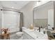 Well-lit bathroom featuring a shower and tub combo, modern vanity, and a sleek black framed mirror at 17551 Gruner Way, Westfield, IN 46062
