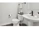 Stylish powder room with pedestal sink, modern fixtures, and decorative accents, clean and bright at 17551 Gruner Way, Westfield, IN 46062