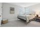 Cozy bedroom with natural light and minimalist decor, featuring a metal bed frame at 17551 Gruner Way, Westfield, IN 46062