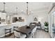Bright dining room with modern chandelier lighting and hardwood floors flows to a lovely kitchen at 17551 Gruner Way, Westfield, IN 46062