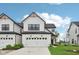 Charming two-story home features a white facade, attached garage, and well-manicured lawn at 17551 Gruner Way, Westfield, IN 46062
