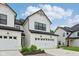 Beautiful home with a white facade, black trim, attached garage, and well-manicured yard at 17551 Gruner Way, Westfield, IN 46062