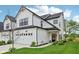 Beautiful home with a white facade, black trim, attached garage, and inviting front entrance at 17551 Gruner Way, Westfield, IN 46062