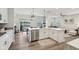 Open concept kitchen with white cabinets, stainless steel appliances, and a seamless flow to dining area at 17551 Gruner Way, Westfield, IN 46062