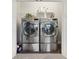 Convenient laundry area with side by side stainless steel washer and dryer and built in shelving at 17551 Gruner Way, Westfield, IN 46062