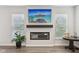 Bright living room featuring a modern fireplace, mounted television, and natural light at 17551 Gruner Way, Westfield, IN 46062