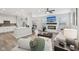Cozy living room and kitchen combo with modern fireplace, stainless appliances, and hardwood floors at 17551 Gruner Way, Westfield, IN 46062