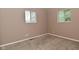 Bedroom with carpet and two windows allowing natural light in at 1802 Sugar Grove Ave, Indianapolis, IN 46202