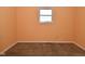 Bedroom with a window, neutral carpet, and peach colored walls at 1802 Sugar Grove Ave, Indianapolis, IN 46202