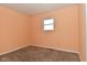 Bedroom featuring neutral carpet, one window, and peach painted walls at 1802 Sugar Grove Ave, Indianapolis, IN 46202