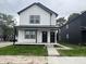 Modern farmhouse-style duplex with contrasting black and white details and covered front porch at 1802 Sugar Grove Ave, Indianapolis, IN 46202