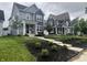 Charming two-story homes with landscaped front yards and inviting entrances on a cloudy day at 1802 Sugar Grove Ave, Indianapolis, IN 46202