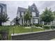 Beautifully landscaped front yard with a lush green lawn and decorative brick retaining wall at 1802 Sugar Grove Ave, Indianapolis, IN 46202