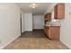 Bright kitchen featuring vinyl flooring, wood cabinets, and light countertops at 1802 Sugar Grove Ave, Indianapolis, IN 46202