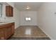 Kitchen area with light walls, vinyl flooring, and wood cabinets at 1802 Sugar Grove Ave, Indianapolis, IN 46202
