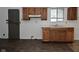 Kitchen with wooden cabinets, light countertops, and newer vinyl flooring at 1802 Sugar Grove Ave, Indianapolis, IN 46202