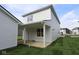 Exterior of home showcasing a covered patio and lush green grass at 1813 Real St, Indianapolis, IN 46240