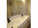 Bright bathroom featuring a double sink vanity with matte black faucets and a shower and tub combo at 1813 Real St, Indianapolis, IN 46240