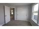 Bedroom features a closet with sliding doors and a window showcasing a tranquil view at 1813 Real St, Indianapolis, IN 46240