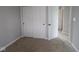 Neutral bedroom showcasing a closet with sliding doors and an additional closet with a door at 1813 Real St, Indianapolis, IN 46240
