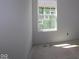 Bedroom with large window features neutral walls, abundant natural light, creating a serene and customizable space for relaxation at 1813 Real St, Indianapolis, IN 46240