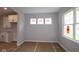 Dining area with large windows and an open view to the kitchen at 1813 Real St, Indianapolis, IN 46240