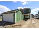 New home featuring attached two-car garage and modern design with green building material at 1813 Real St, Indianapolis, IN 46240