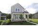 Charming two-story home features board and batten siding, stone accents and a well-manicured lawn at 1813 Real St, Indianapolis, IN 46240