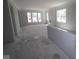 Open-concept living room with multiple windows offers bright, flexible space, ready for personalized design and comfortable living at 1813 Real St, Indianapolis, IN 46240