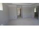 The main bedroom features tray ceiling, a doorway, and white walls creating a serene atmosphere and customizable space at 1813 Real St, Indianapolis, IN 46240