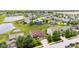 Aerial view of a beautiful home with a well-manicured lawn, trees, and a nearby pond at 1821 Midnight Pass, Brownsburg, IN 46112
