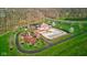 High-angle view of community amenities, including a pool, playground, trees and winding walking paths at 1821 Midnight Pass, Brownsburg, IN 46112