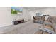 Open basement layout with a large brown leather sectional sofa, entertainment center, and TV at 1821 Midnight Pass, Brownsburg, IN 46112