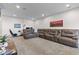 Large open basement rec room with brown leather sectional and neutral colored carpet at 1821 Midnight Pass, Brownsburg, IN 46112