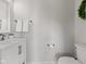 Clean half-bathroom with white vanity, modern fixtures, and a decorative wreath at 1821 Midnight Pass, Brownsburg, IN 46112