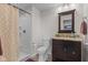 Full bathroom with a tiled shower, granite vanity, and decorative mirror at 1821 Midnight Pass, Brownsburg, IN 46112
