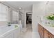 Luxurious primary bath with a soaking tub, glass enclosed shower, and walk-in closet at 1821 Midnight Pass, Brownsburg, IN 46112