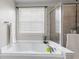 A bright bathroom features a large tub with a window and shower at 1821 Midnight Pass, Brownsburg, IN 46112