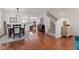 Dining area with hardwood floors, adjacent to the living room, and staircase at 1821 Midnight Pass, Brownsburg, IN 46112