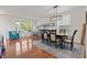 Spacious dining area featuring hardwood floors, modern lighting, and adjacent workspace at 1821 Midnight Pass, Brownsburg, IN 46112